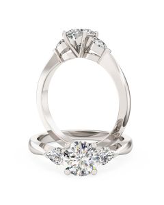 A beautiful round brilliant cut diamond ring with pear shoulder stones in 18ct white gold