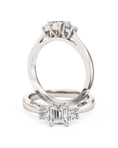 An emerald cut and round brilliant cut three stone diamond ring in 18ct white gold