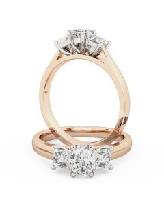 A stunning oval and princess cut three stone diamond ring in 18ct rose & white gold