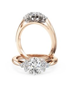 An oval and round brilliant cut diamond ring in 18ct rose & white gold
